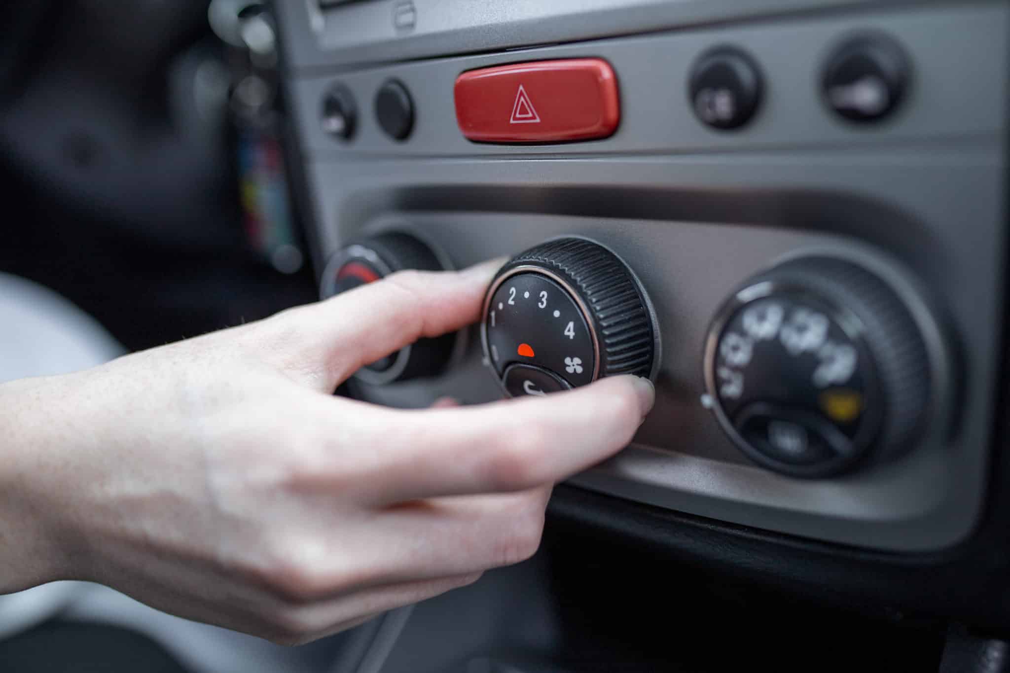 woman hand turning car air conditioning system car air conditioner off button close up view scaled - Groupe Alsoweb